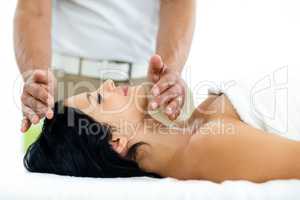 Pregnant woman receiving a spa treatment from masseur