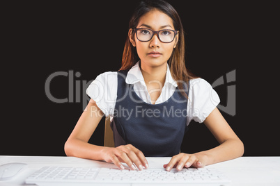 Serious businesswoman using a computer