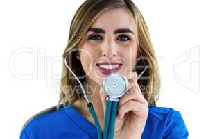 Smiling nurse using stethoscope