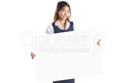 Smiling businesswoman holding a white poster