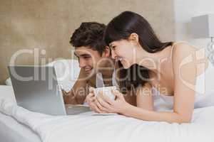 Young couple looking at laptop