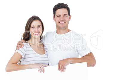 Happy couple holding a poster