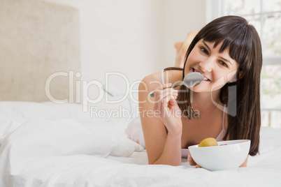 Woman having breakfast on bed