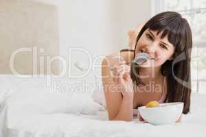 Woman having breakfast on bed