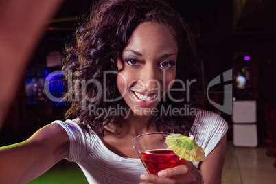 Portrait of young woman having a cocktail