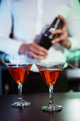 Two glasses of cocktail on bar counter