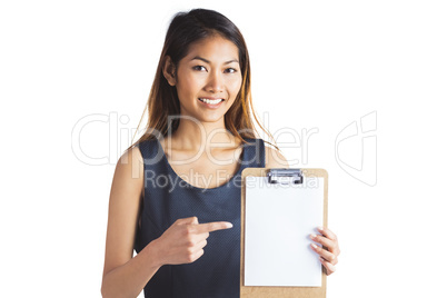 Smiling businesswoman pointing a clipboard