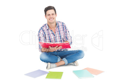 Man reading a book while sitting on the floor