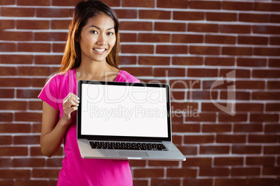 Smiling asian woman holding computer