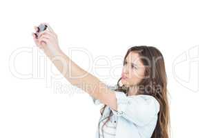 Smiling young woman taking a selfie while grimacing