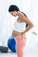 Pregnant woman looking down while exercise