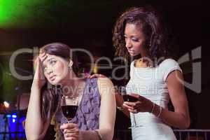 Woman having drinks and comforting her depressed friend