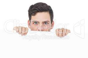 Handsome man holding a white poster