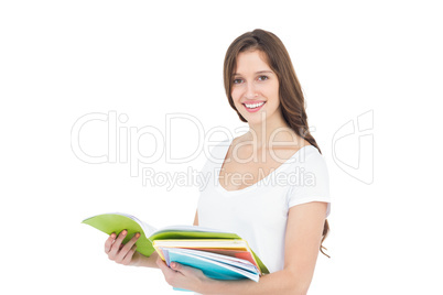 Portrait of happy female college student holding books