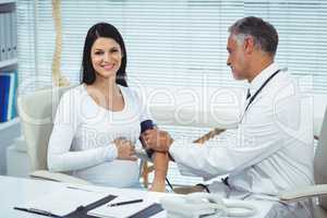 Doctor measuring pressure of pregnant woman