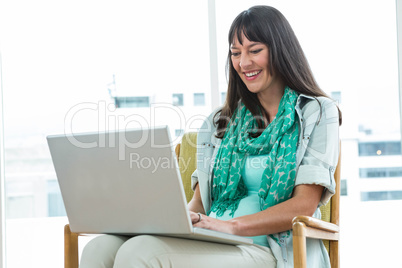 Pregnant woman using laptop