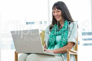 Pregnant woman using laptop