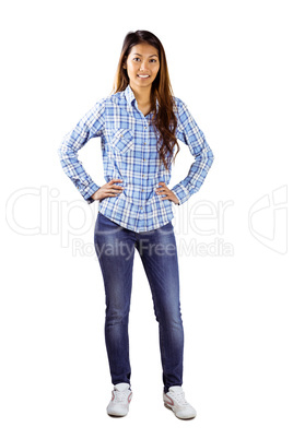 Smiling asian woman with hands on hips