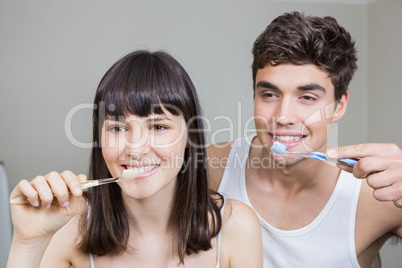 Young couple brushing their teeth