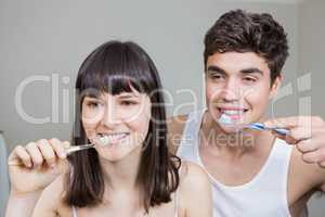 Young couple brushing their teeth