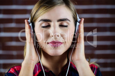 Pretty blonde woman listening to music