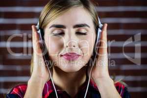 Pretty blonde woman listening to music