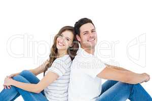 Young couple sitting on floor back to back