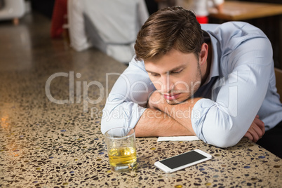 Tired man leaning on counter