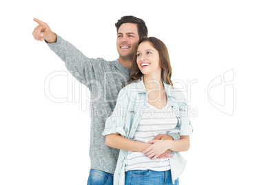 Couple embracing and pointing up