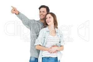 Couple embracing and pointing up