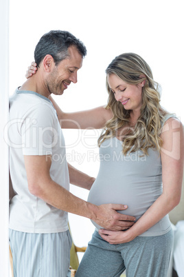 Man holding pregnant womans stomach