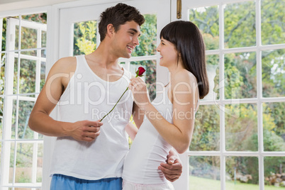 Man offering a red rose to woman