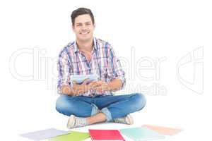 Man using a tablet while sitting on the floor