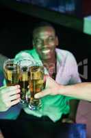 Group of men toasting with glass of beer