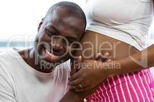 Man listening to pregnant womans stomach