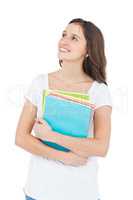 Smiling female college student holding books