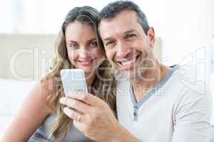 Couple looking at smartphone