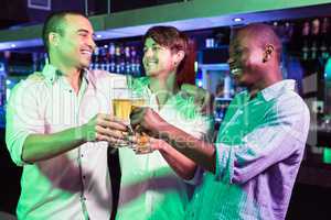 Group of men toasting with glass of beer