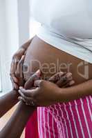 Man touching pregnant woman belly