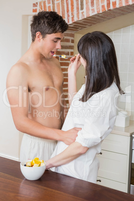 Woman feeding fruits to man