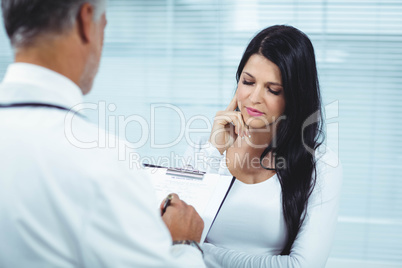 Pregnant woman interacting with doctor