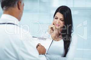 Pregnant woman interacting with doctor