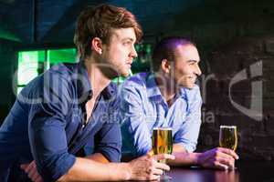 Two men having beer at bar counter