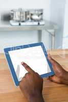 Man using digital tablet in kitchen