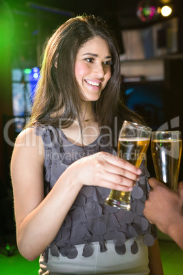 Beautiful woman toasting her beer glass