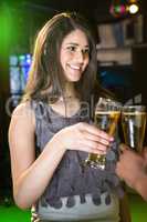 Beautiful woman toasting her beer glass