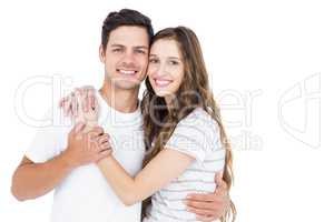 Cute couple embracing and looking the camera