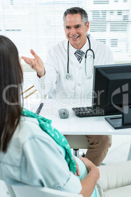 Doctor interacting with a pregnant woman at clinic