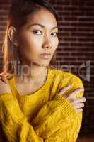 Serious asian woman with hands on shoulders