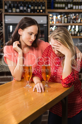 Cute friends having a glass of beer